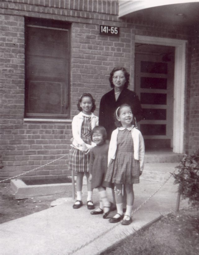 Mrs. Ruth Mulan Chu Chao with their 3 daughters in front of their first apartment building in America in Queens, New York.