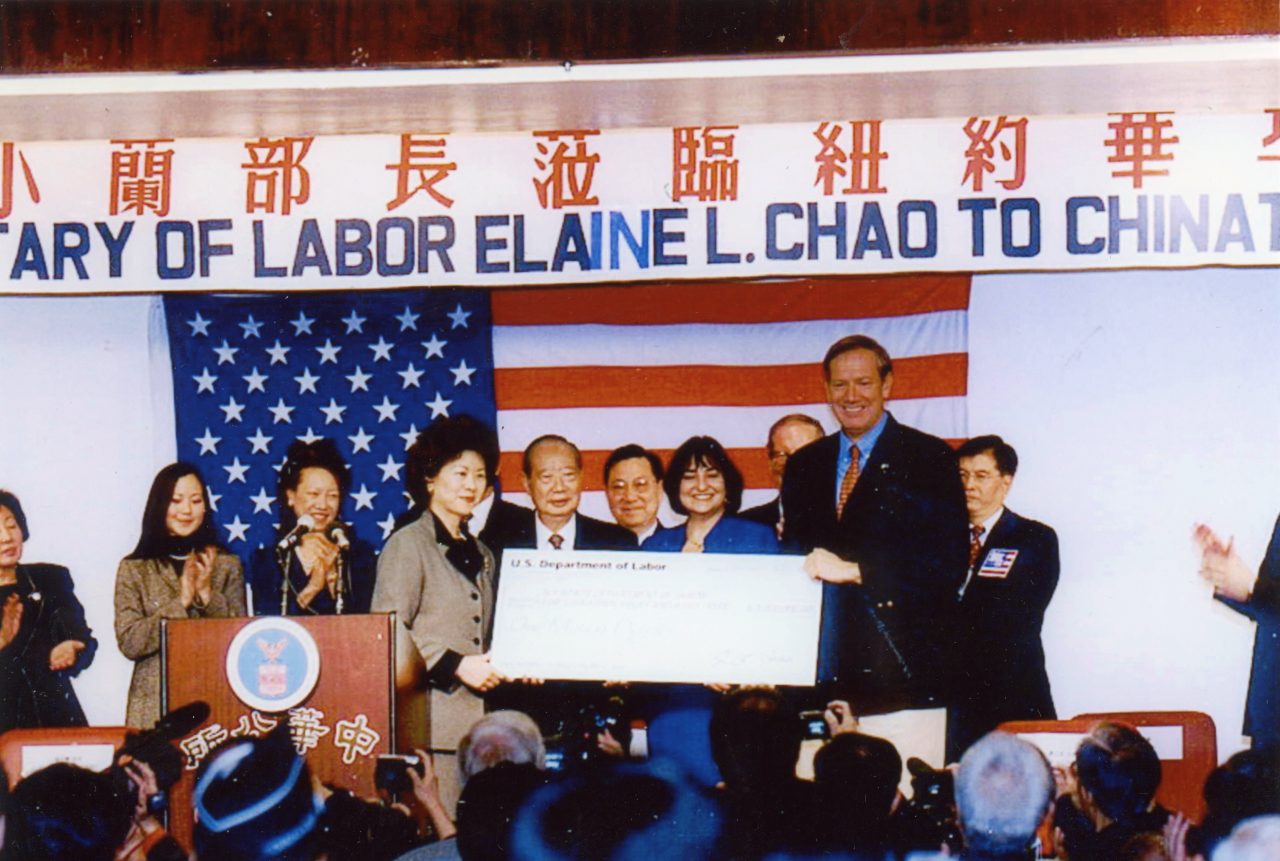 Secretary of Labor Elaine Chao presenting a check for $1,000,000 to Chinatown to help residents recover from the economic devastation of the attacks of September 11, 2001 with New York Governor George Pataki.