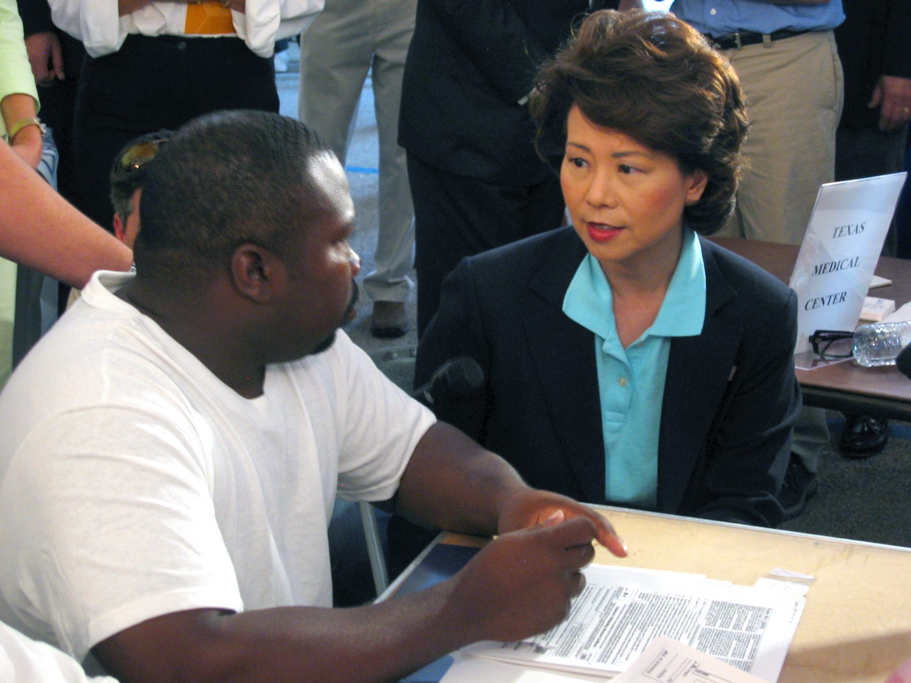 Secretary Elaine Chao talking to a displaced worker at an employment center in the gulf region after Hurricane Katrina.