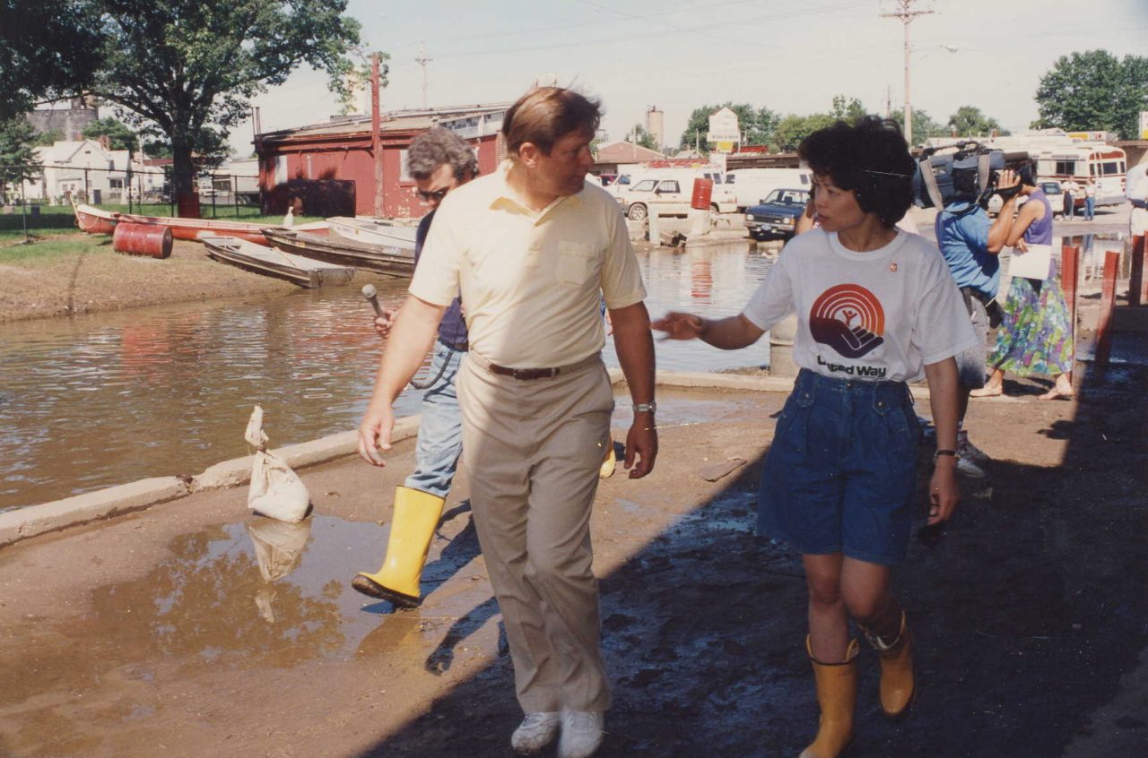 United Way of America President & CEO Elaine Chao talking with a local official during a tour to a flooded region in the Midwest.