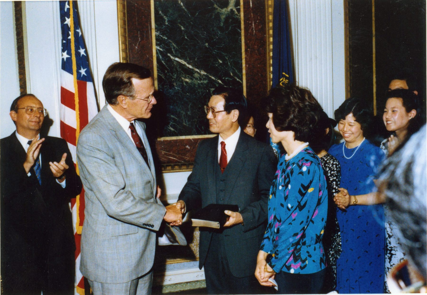 Vice President George H.W. Bush shakes hands with Dr. James S. C. Chao after swearing in Federal Maritime Commission Chairman Elaine Chao.