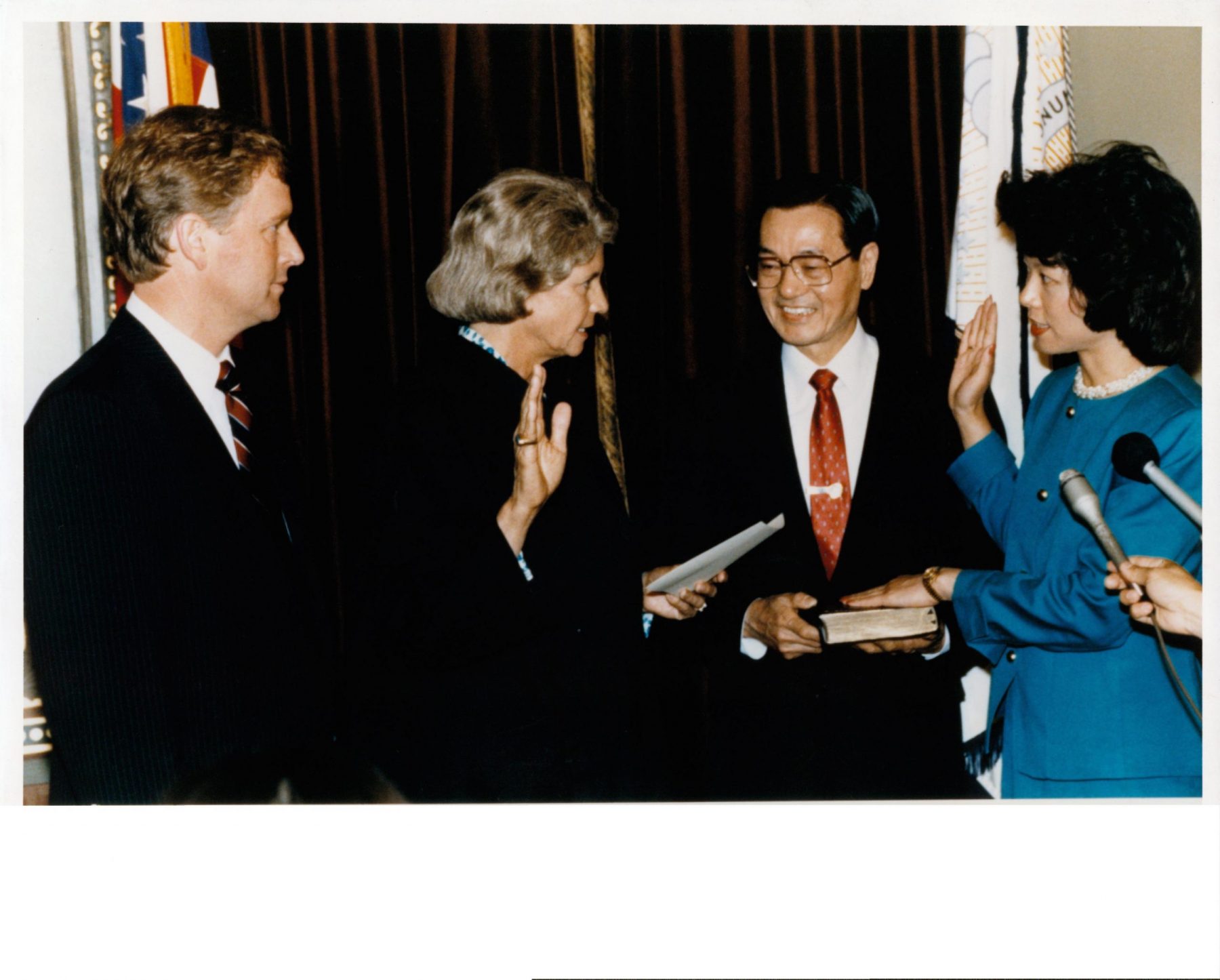 Elaine Chao being sworn in as U.S. Deputy Secretary of Transportation by Supreme Court Justice Sandra Day O'Connor with father, Dr. James S. C. Chao, holding the Bible and Vice President Dan Quayle witnessing.